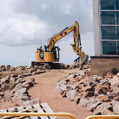 An excavator working over broken rock